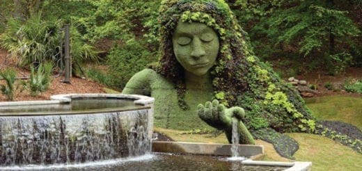 Topiary sculpture of a goddess with plants and a fountain at the Atlanta Botanical Garden.