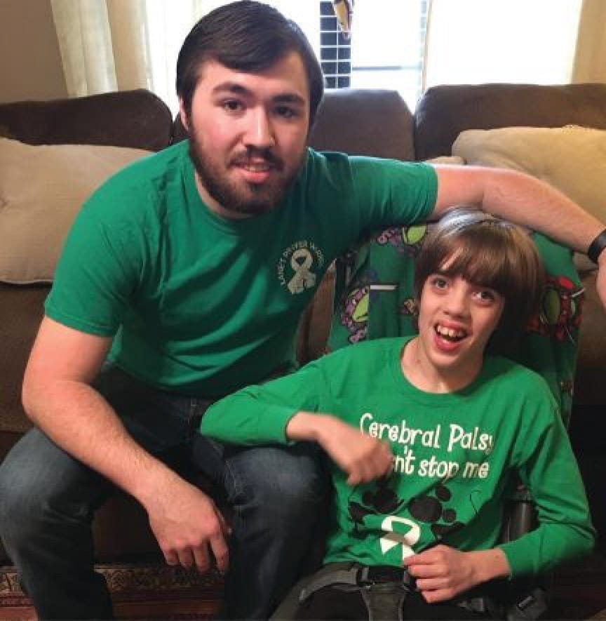 Lane and his brother Connor in matching green shirts.