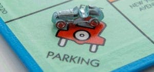 Monopoly car tokens on the parking space.