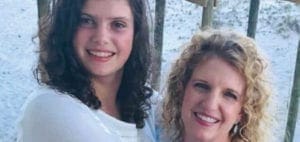 Julie Hornok with a young woman smiling outdoors.