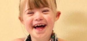 Lila Morrow laughing with her eyes closed.