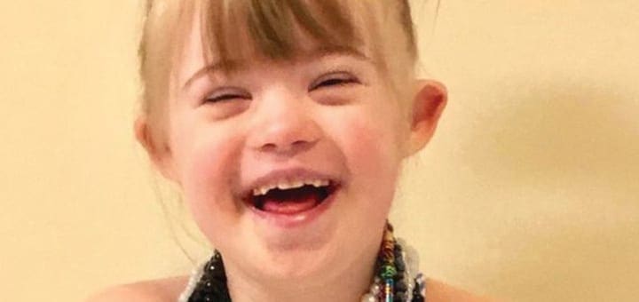 Lila Morrow laughing with her eyes closed.