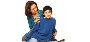 Adult supporting a child sitting with a book.