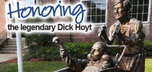 Bronze statue of Dick Hoyt pushing his son Rick Hoyt in a wheelchair.