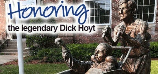 Bronze statue of Dick Hoyt pushing his son Rick Hoyt in a wheelchair.
