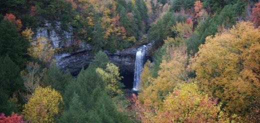 Foster Falls waterfall surrounded by colorful autumn foliage.