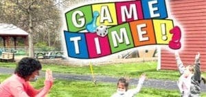 Game Time text with a dice and game pieces above a park setting with people playing.