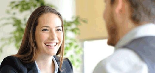 Woman smiling while looking at a man in a vest