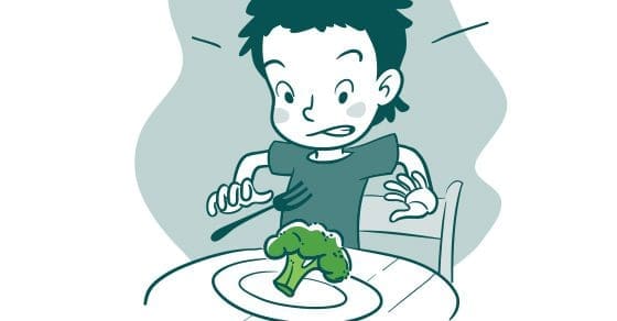 A child with a disgusted expression holds a fork over a piece of broccoli on a plate.