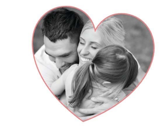 A couple hugs their daughter inside a heart shape