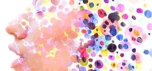 Colorful watercolor dots in various sizes on a white background.