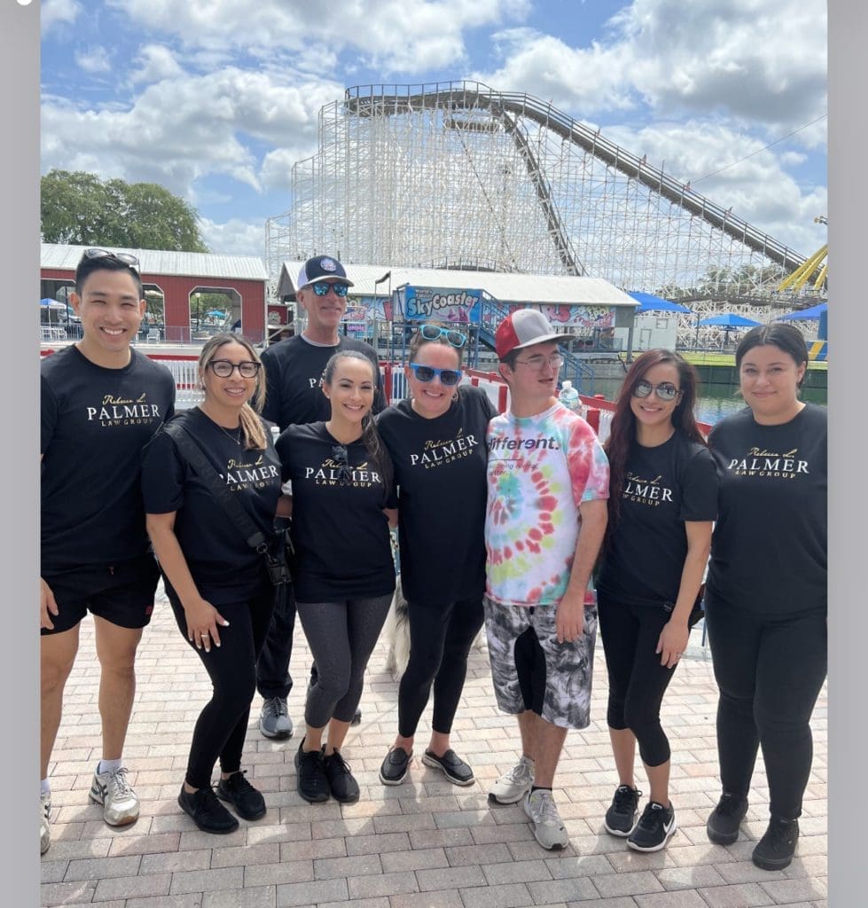 Group of people wearing Palmer t-shirts at an amusement park.