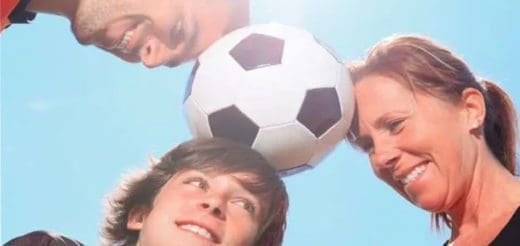 A family with a soccer ball between their heads