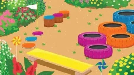 An outdoor obstacle course with colorful tires, stepping stones, and a bench.