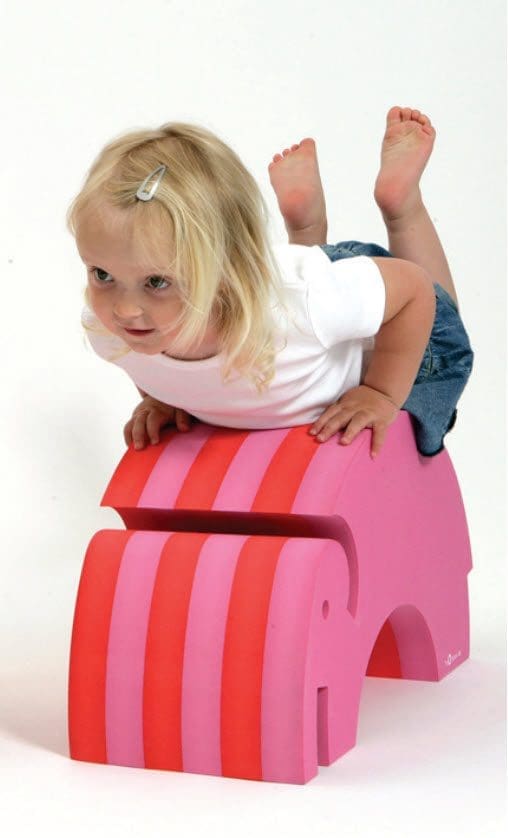 A child climbs on a pink and orange striped Bobles Tumbling Elephant.