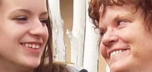 Two people smiling at each other.