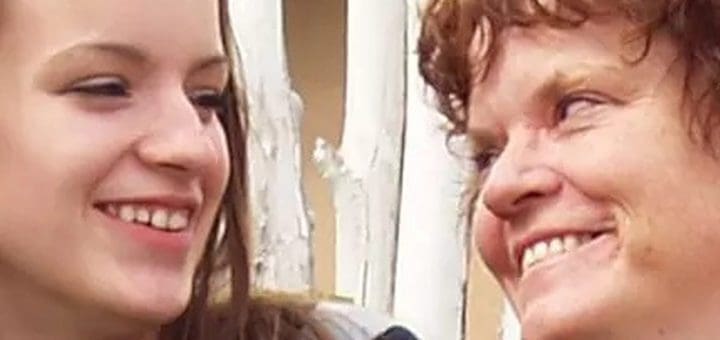 Two people smiling at each other.