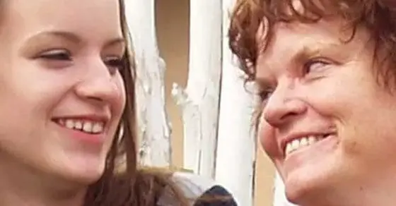Two women smiling at each other
