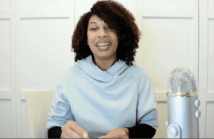 Dr. Cherina Williams speaking at a table with a microphone.