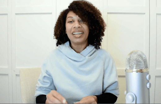 Dr. Cherina Williams speaking at a table with a microphone.