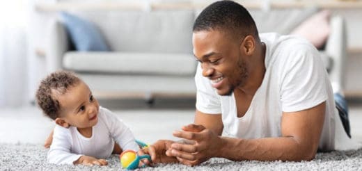 Man and baby playing on the floor