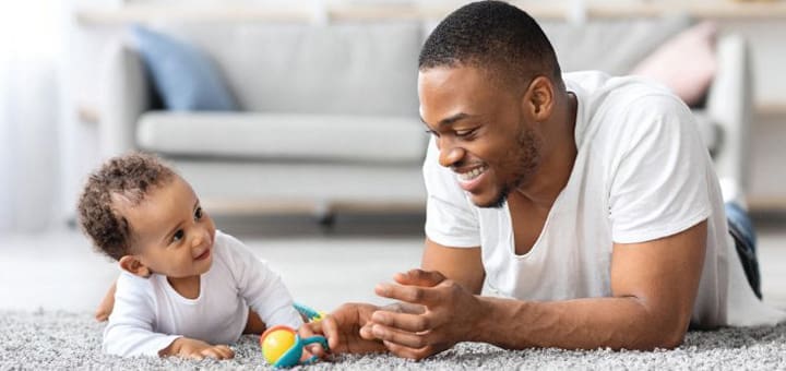 Man and baby playing on the floor