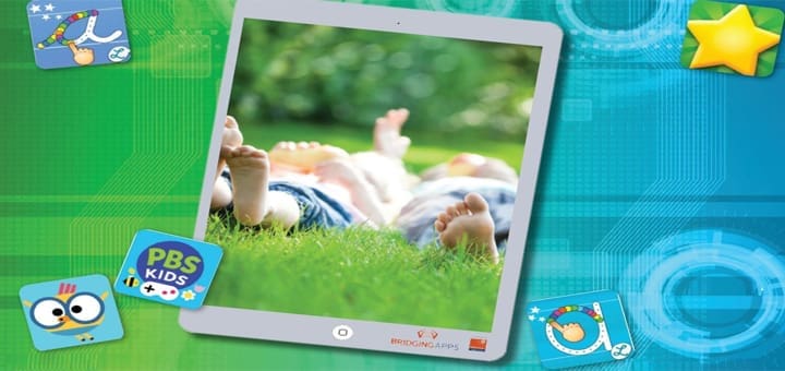 Tablet displaying a child lying on grass with PBS Kids icons around it.