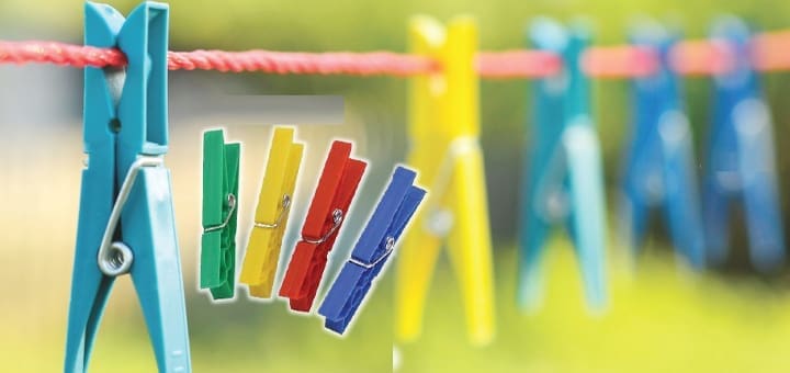 Clothesline with colorful clothespins and a blue clothespin in the foreground.