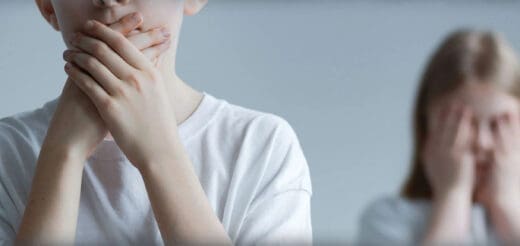 Children covering their mouths and faces.