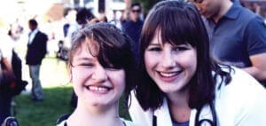Dr Deanna Clauss and her sibling smile at the camera