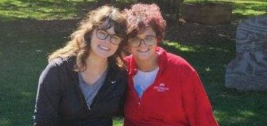 Dr. Emily Gianetti posing outdoors with her sibling.