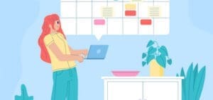 Woman using a laptop in front of a calendar with tasks.