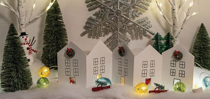 Paper chain houses and trees create a winter village scene.