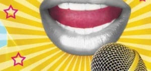 Close-up of a mouth open in song next to a microphone
