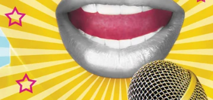 Close-up of a mouth open in song next to a microphone