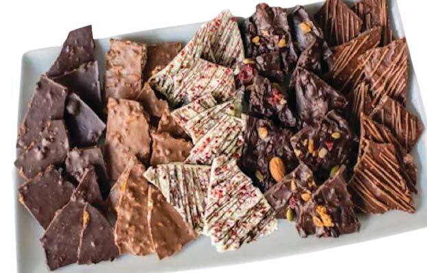 Assortment of chocolate bark pieces on a white platter