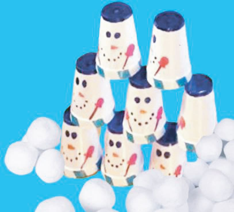 Snowman cups stacked in a pyramid with white snowball-like objects around them.