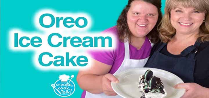 Two women present a slice of Oreo ice cream cake.