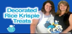 Two women display decorated Rice Krispie treats.