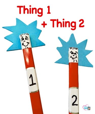Thing 1 and Thing 2 pencil toppers with blue spiky hair and faces drawn on white labels.