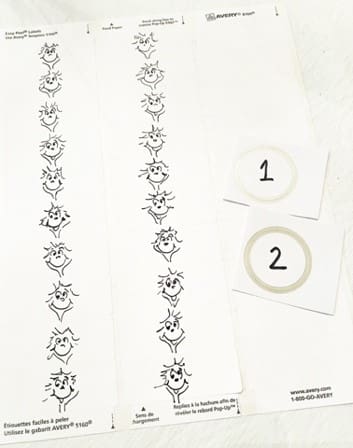 Strips of paper with printed Dr. Seuss characters and two numbered circles.