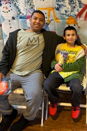 Gabriel and Sam sitting together on chairs.