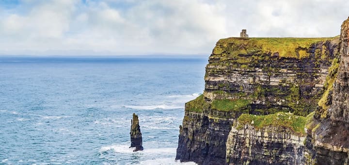 The Cliffs of Moher in Ireland with the ocean in the background.