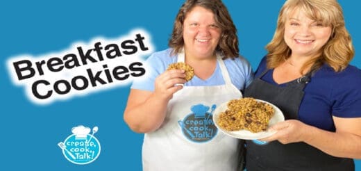 Two women smile, one holds a plate of breakfast cookies and the other holds a cookie.