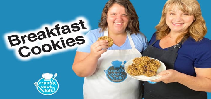 Two women smile, one holds a plate of breakfast cookies and the other holds a cookie.