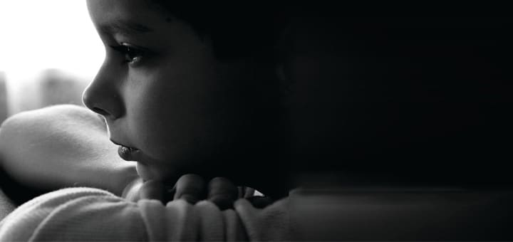 Profile of a child looking into the distance.