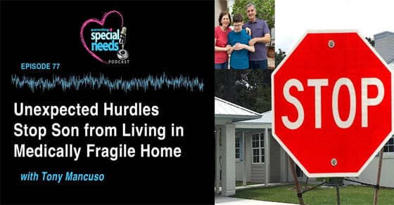 Stop sign in front of a house with a family standing behind it.