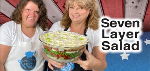 Two women present a seven-layer salad.