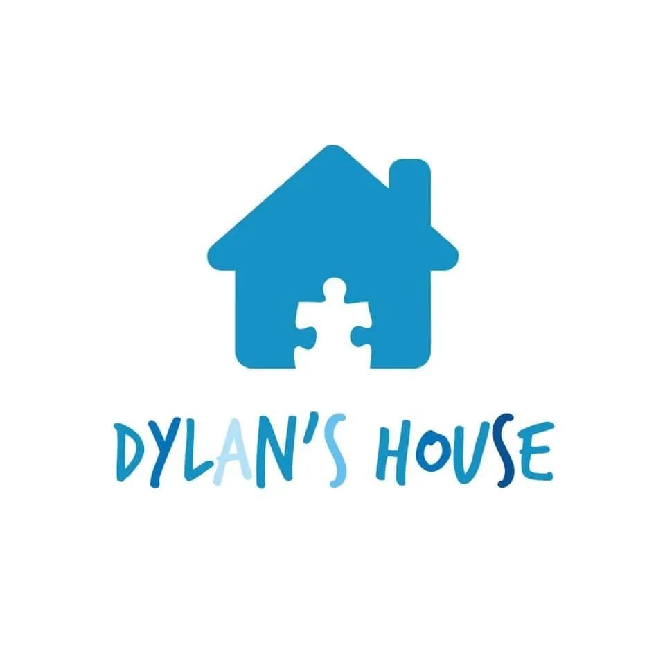 Logo for Dylan's House featuring a blue house icon with a puzzle piece cut out, and the words "DYLAN'S HOUSE" below.