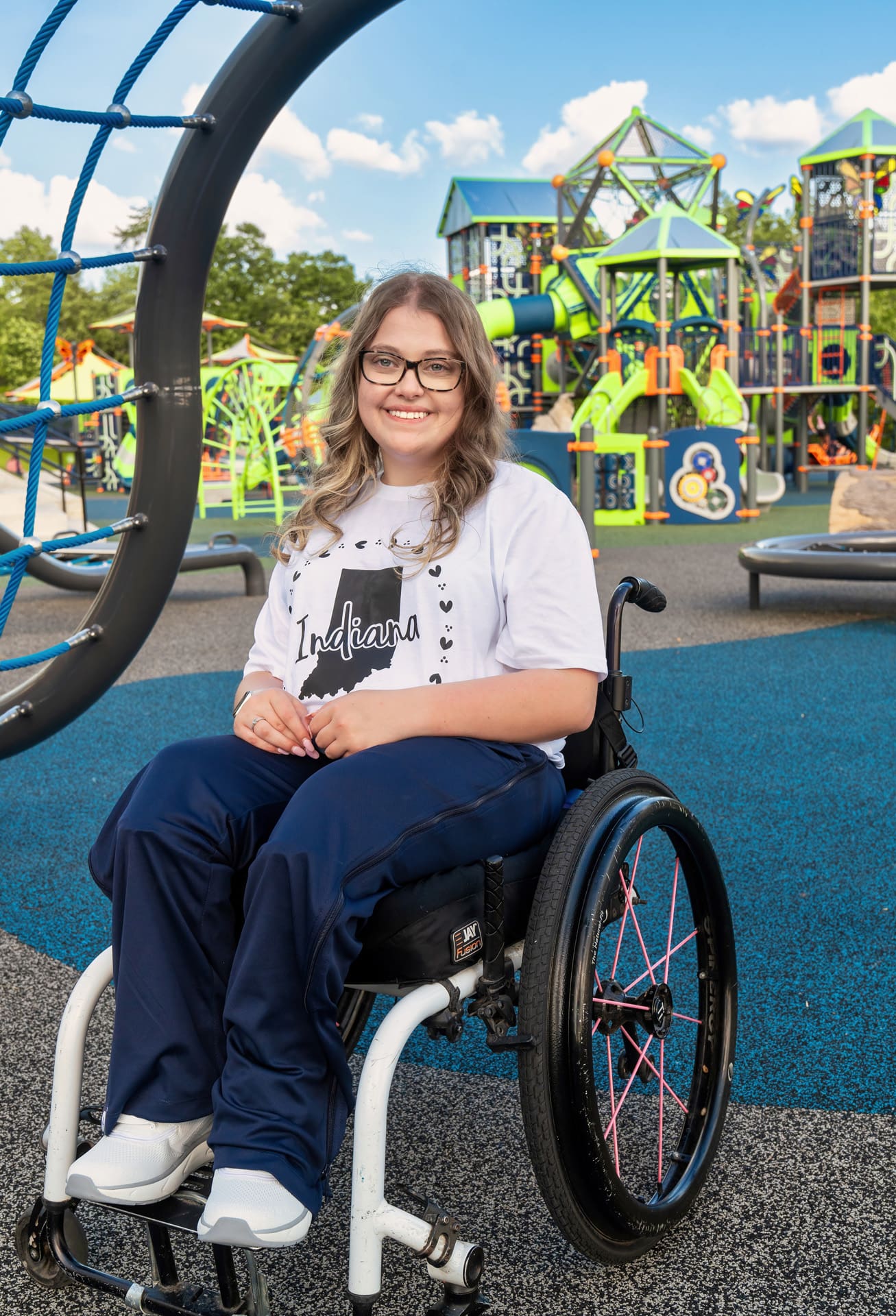 Young person in a wheelchair smiling at Possibility Playground in Corydon, Indiana.